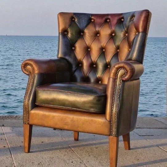 Tufted leather armchair with wooden legs on seaside patio