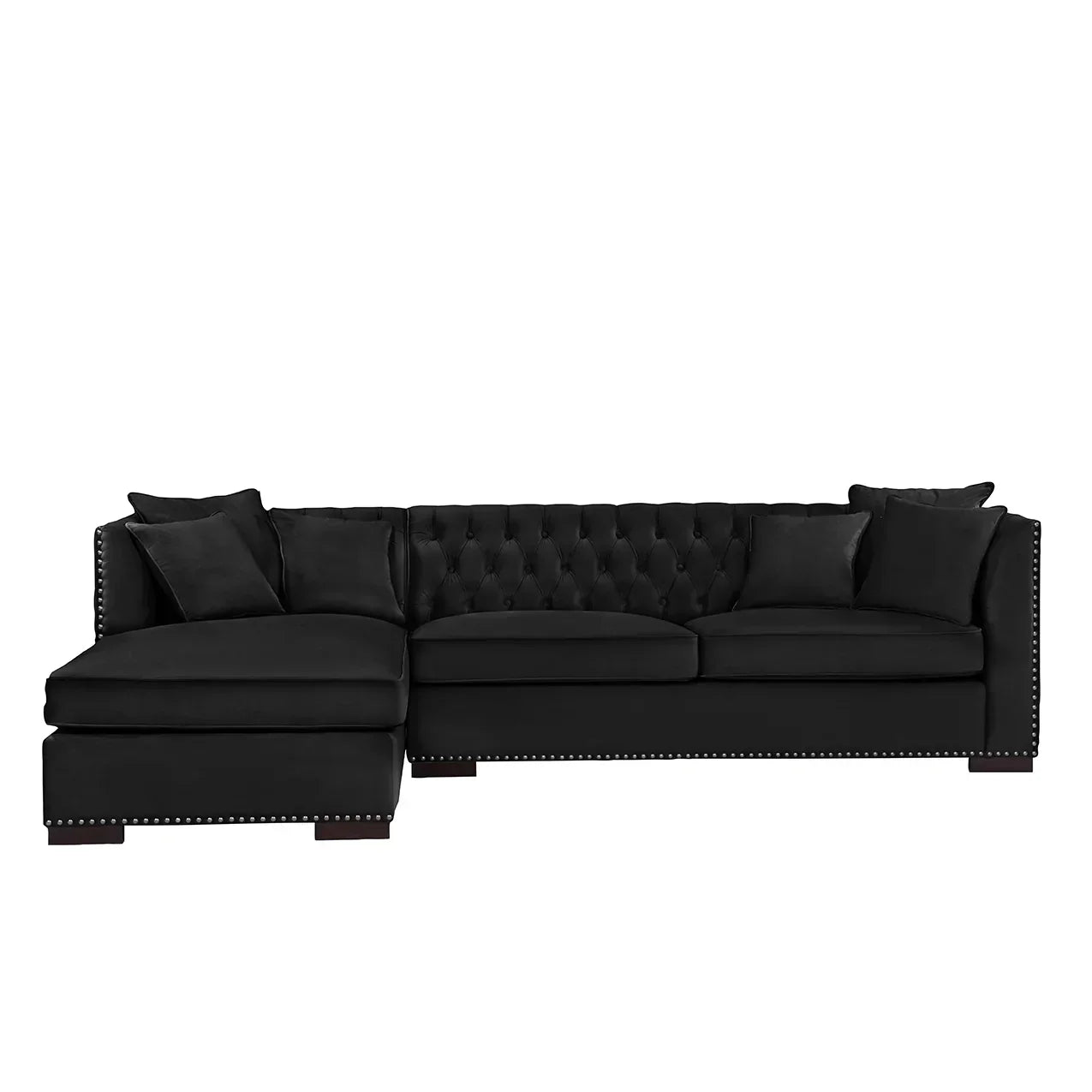 Black velvet corner sofa with tufted back, nailhead trim, and matching scatter cushions