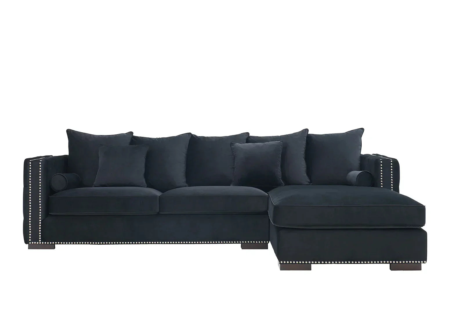 Black velvet corner sofa with studded trim and multiple scatter cushions, right-hand chaise design