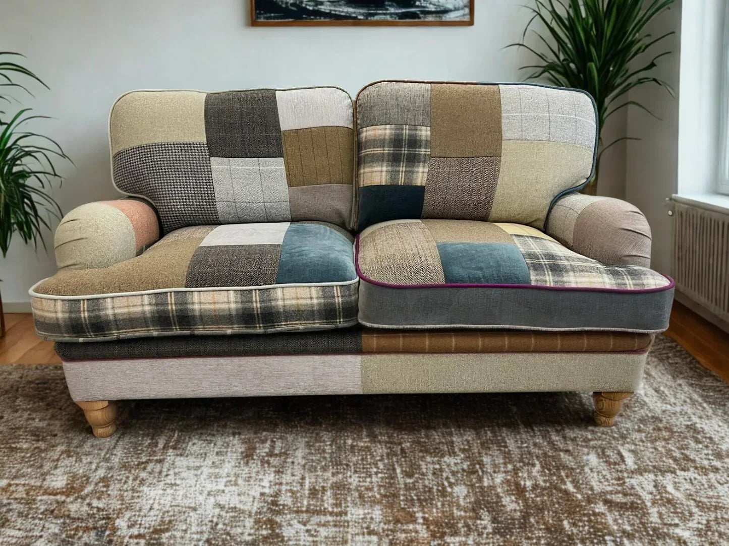 Patchwork fabric sofa with wooden legs on a patterned rug in a bright living room