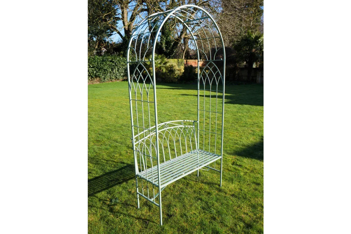 Metal garden bench with arch frame on lawn, decorative outdoor seating