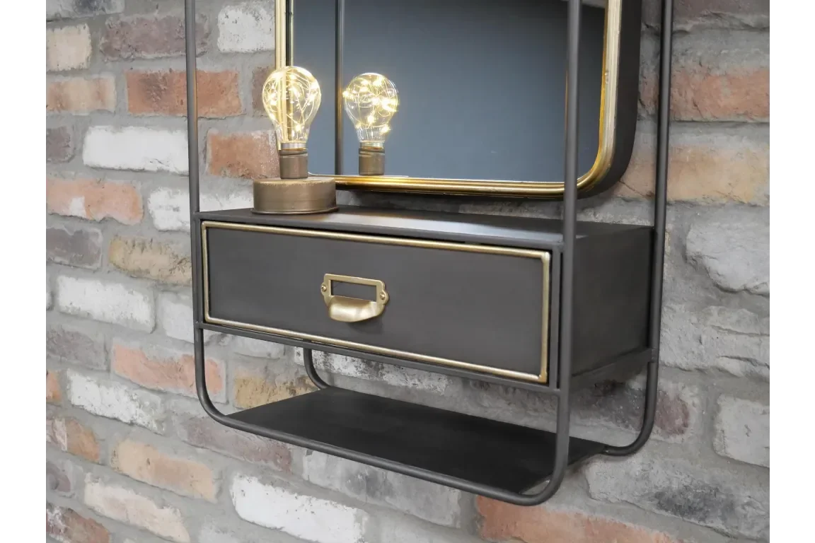 Industrial wall shelf with drawer, brass trim, and Edison bulbs against brick wall
