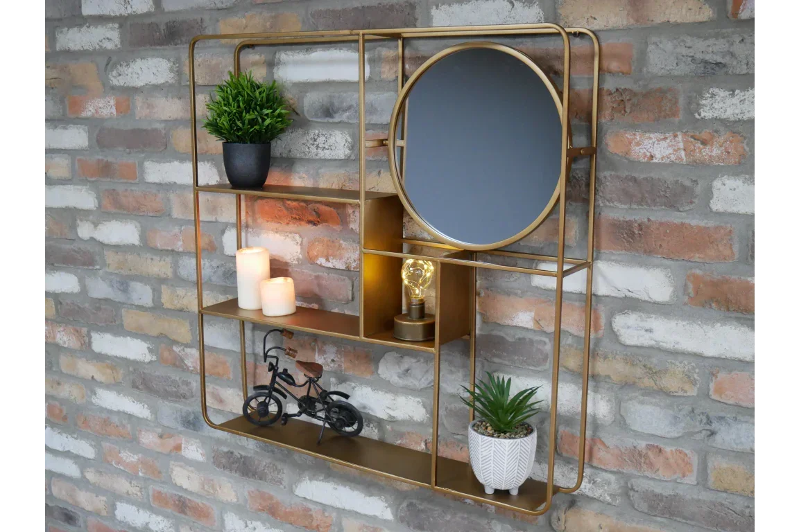 Gold wall shelf with round mirror, candles, potted plants, and decorative bike on brick wall