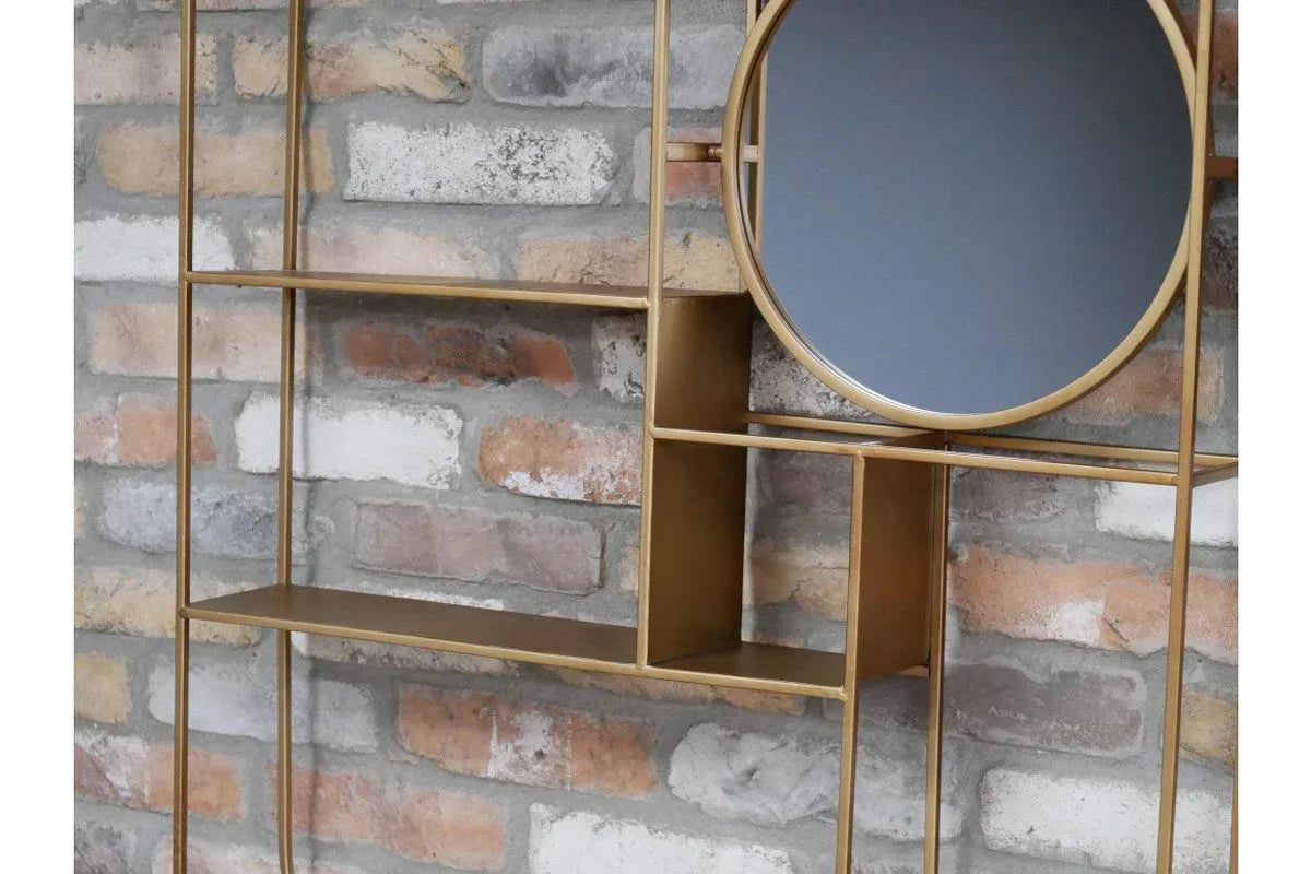 Gold metal wall shelf with geometric shelves and round mirror against brick wall
