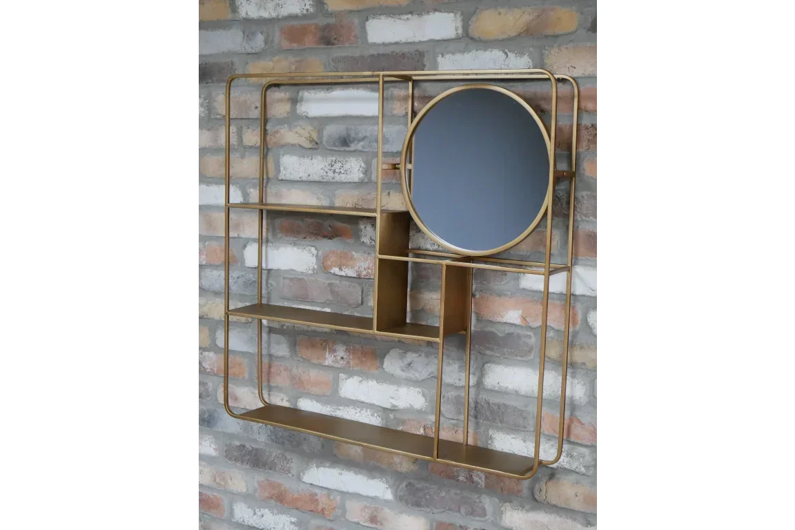 Gold metal wall shelf with round mirror and open compartments on brick wall