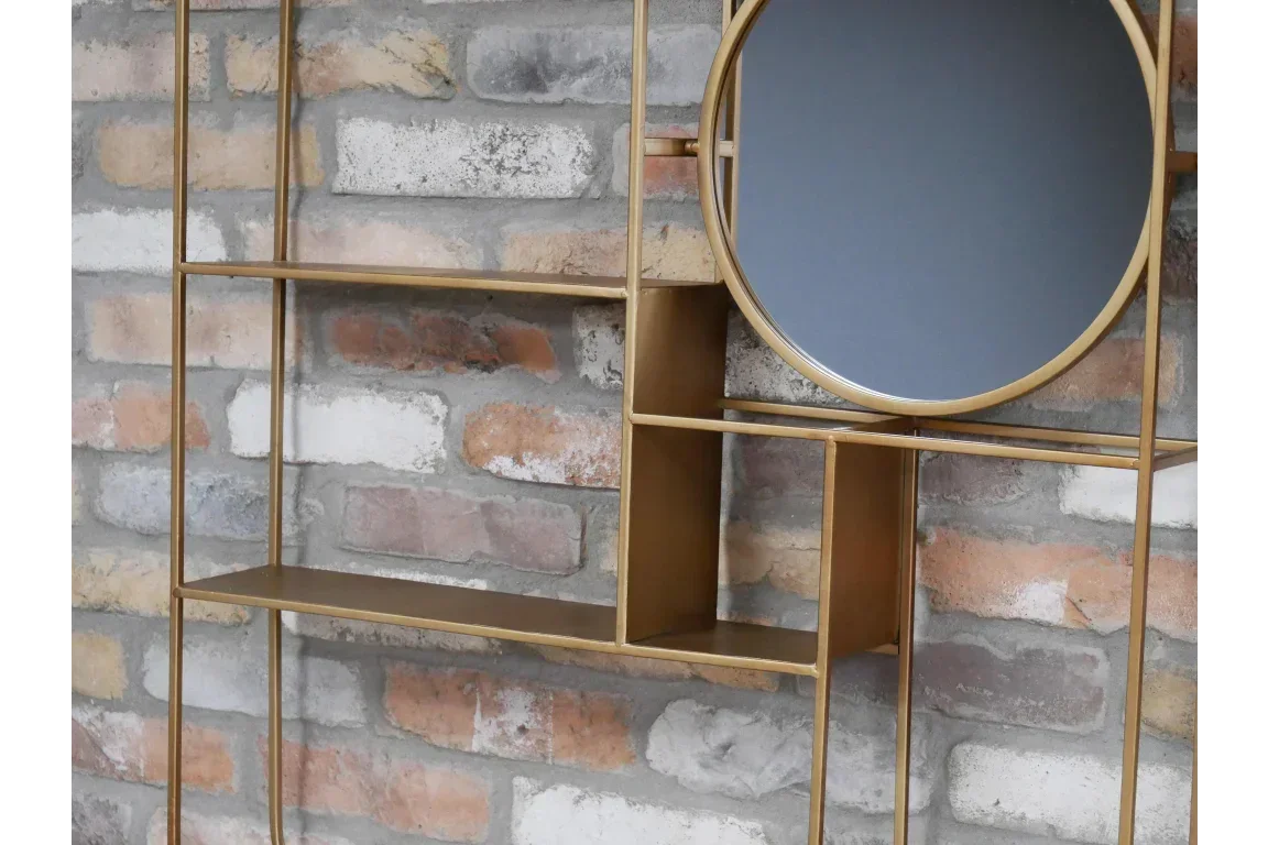 Gold metal wall shelf with round mirror and open shelving against brick wall