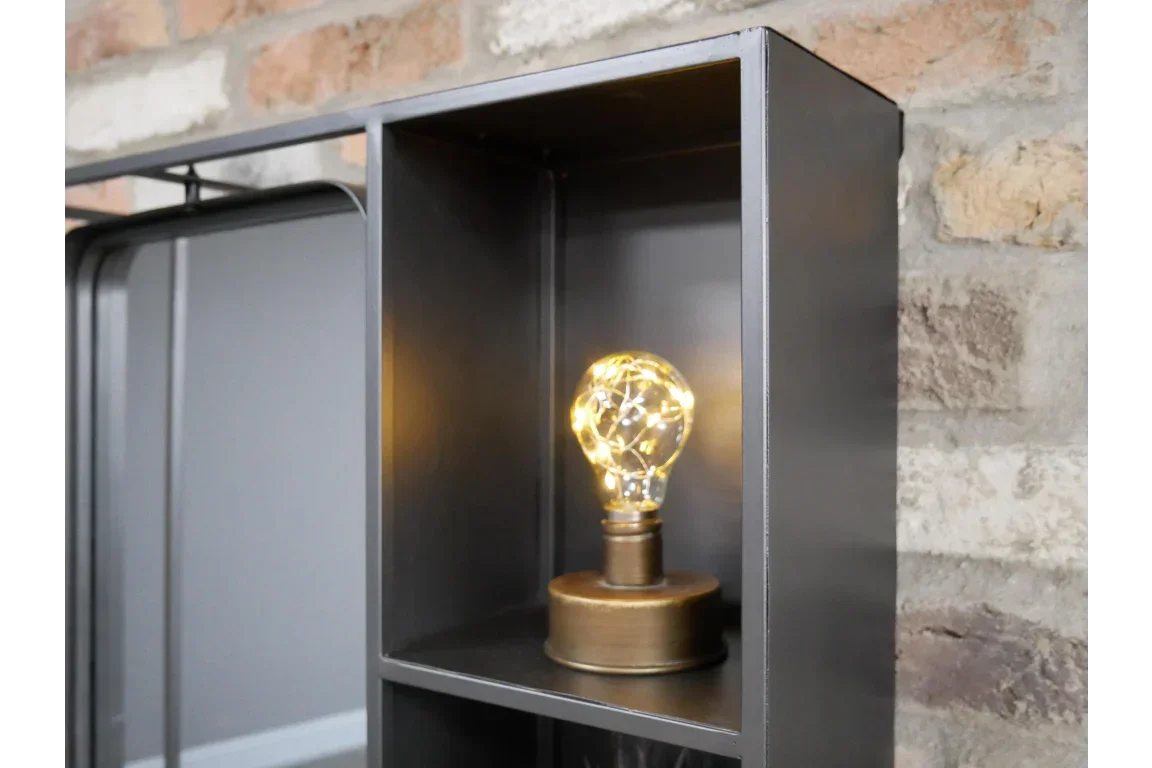 Industrial metal cabinet shelf with decorative LED bulb lamp against brick wall