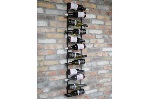 Vertical black metal wine bottle holder mounted on exposed brick wall, storing ten bottles horizontally.
