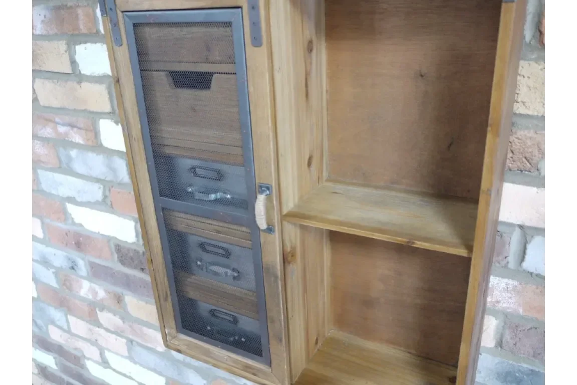 Wood wall cabinet with mesh-front drawers and open shelving against brick wall