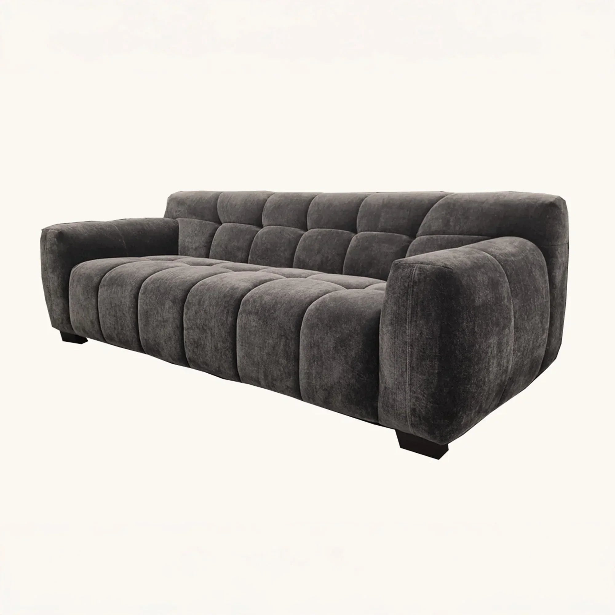 Charcoal grey fabric sofa with deep tufted seat and backrest, angled left view
