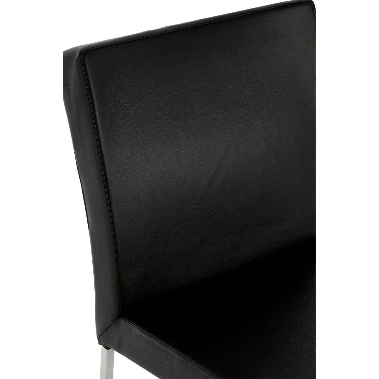 Close view of black leather dining chair backrest with smooth upholstery and silver frame