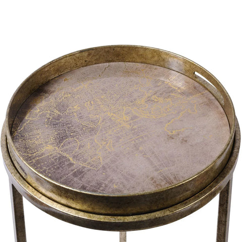 Antique gold tray table with map design on round surface.