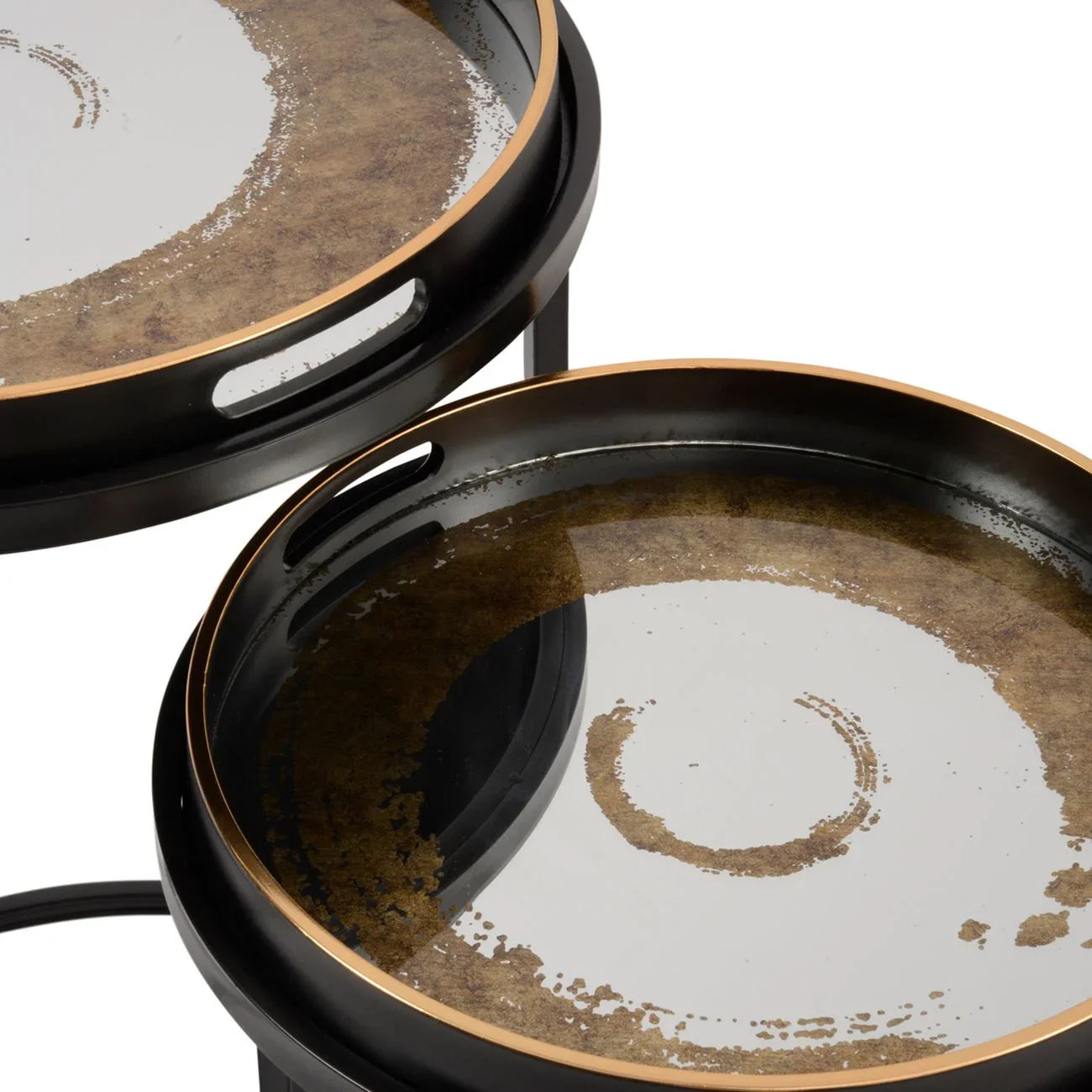Black and gold round tables with swirling pattern and raised edges.