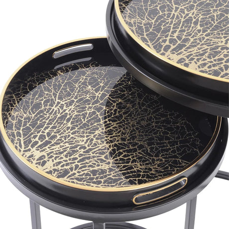 Black and gold tray tables with intricate coral pattern design.