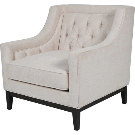 Ivory fabric armchair with buttoned back and dark wooden legs.