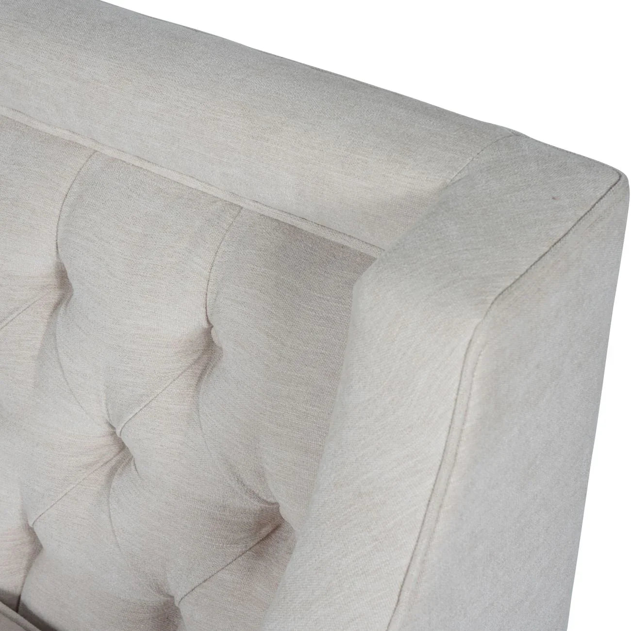 Ivory armchair with buttoned back detail and soft fabric texture.