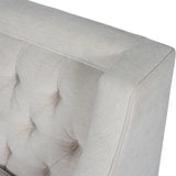 Ivory armchair with buttoned back detail and soft fabric texture.