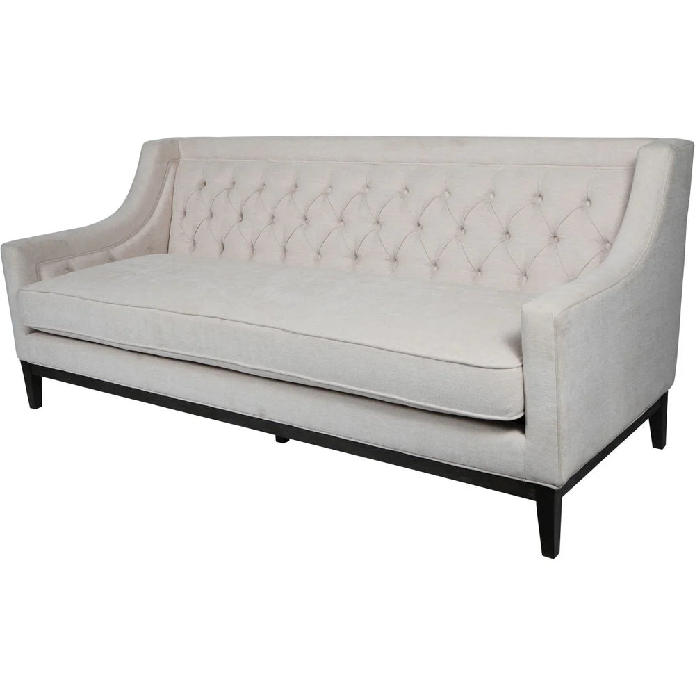 Ivory fabric sofa with buttoned backrest and sleek black legs.