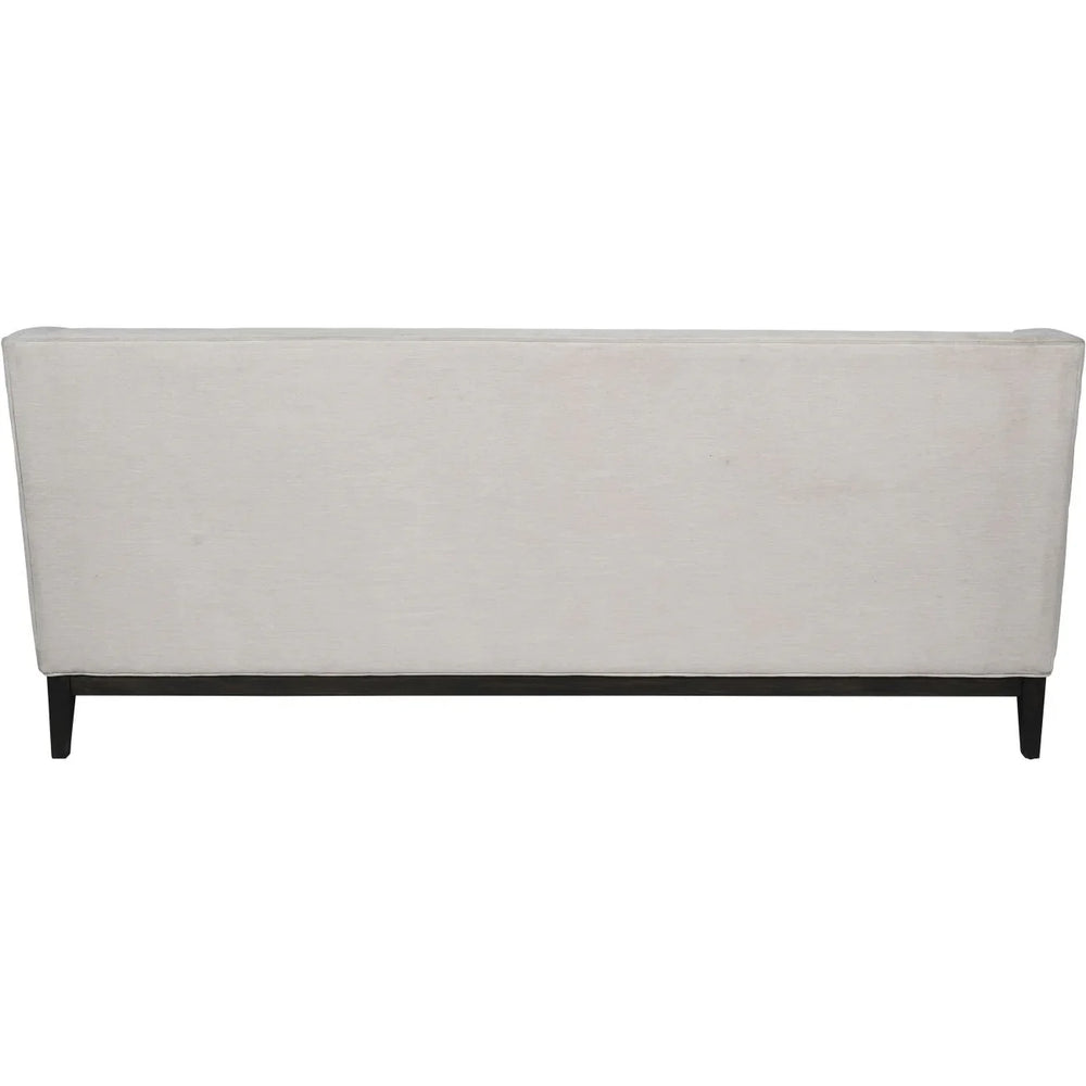 Back view of ivory fabric sofa with dark wooden legs