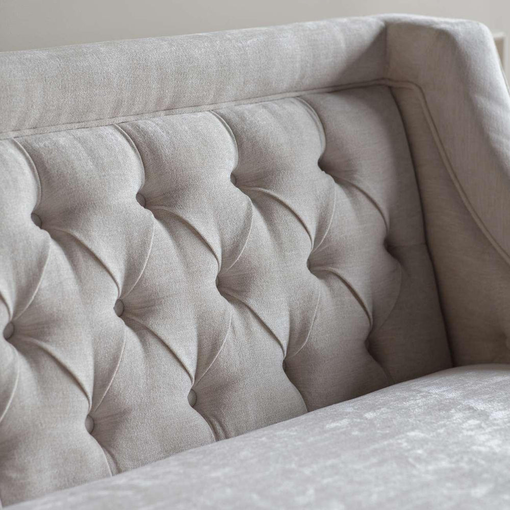 Ivory sofa backrest with elegant button tufting detail