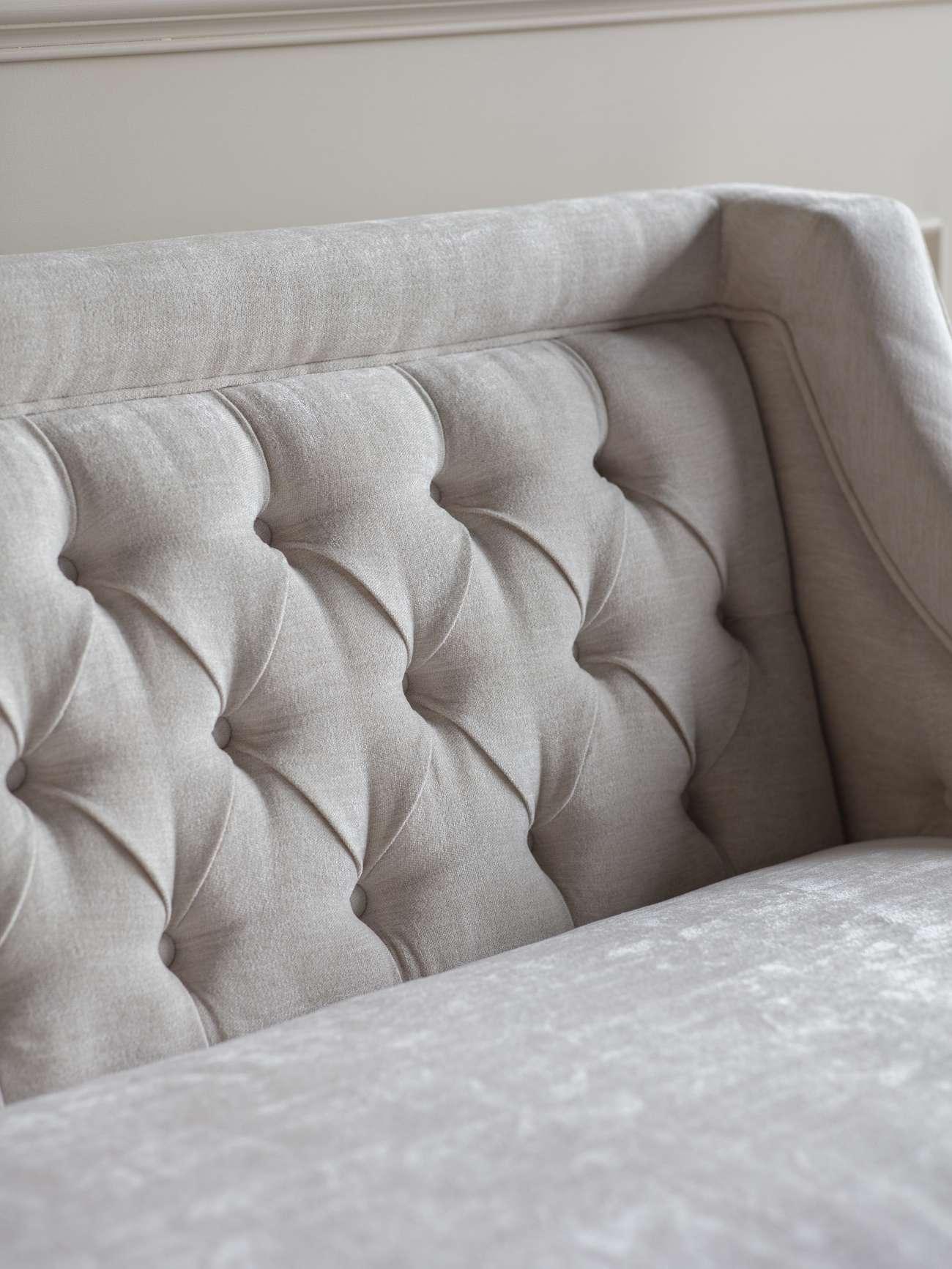 Ivory sofa backrest with elegant button tufting detail