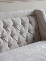 Ivory sofa backrest with elegant button tufting detail