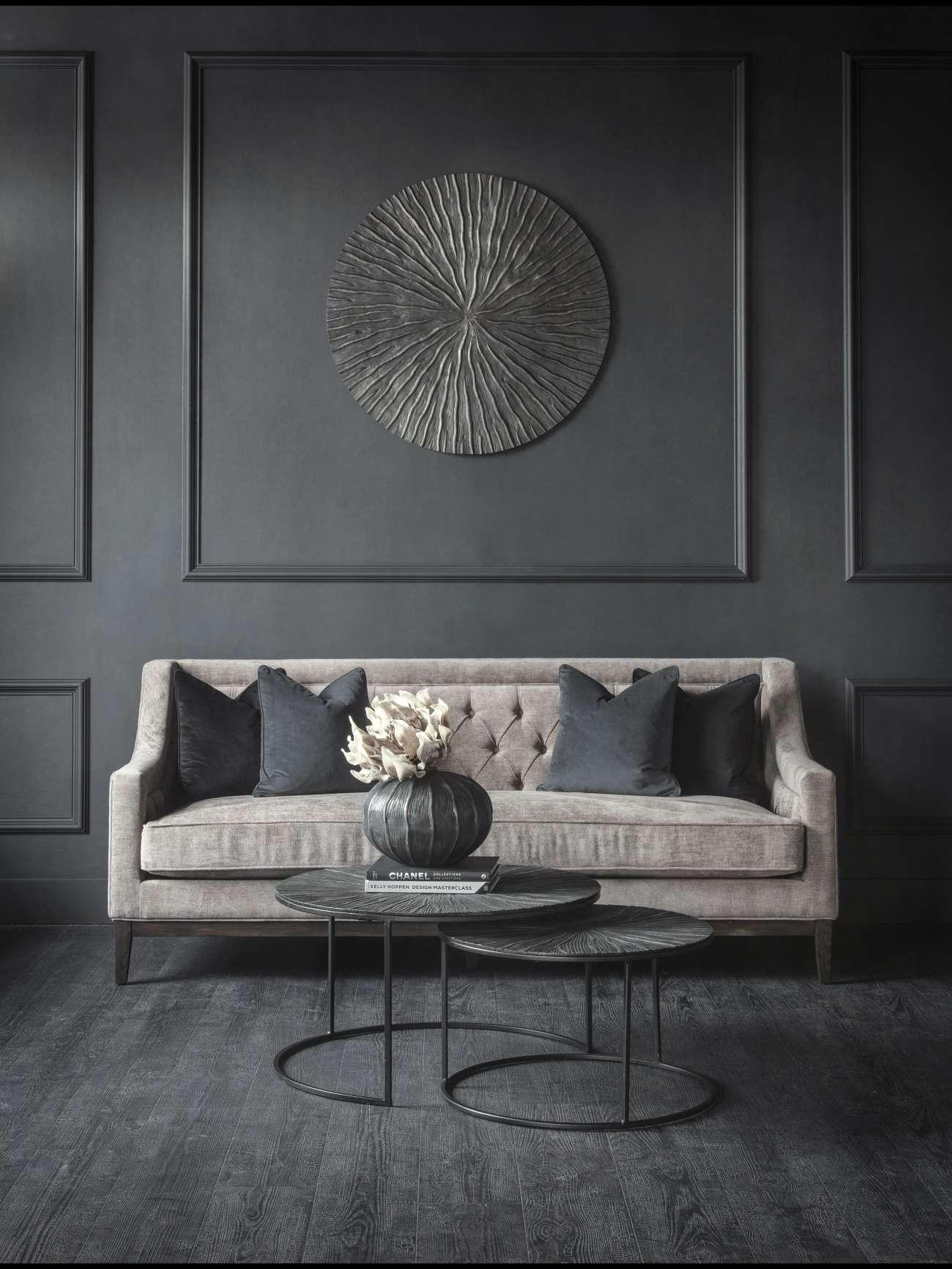Warm grey sofa with dark cushions in an elegant living room setting.