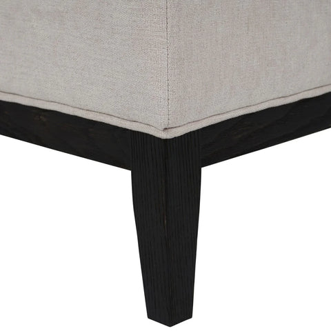 Ivory fabric stool corner with dark wooden leg detail