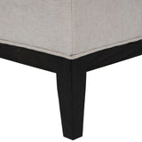 Ivory fabric stool corner with dark wooden leg detail