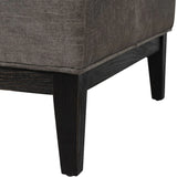 Warm grey fabric stool corner with dark wooden legs.