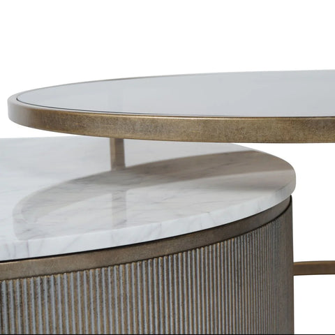 Aged gold nesting tables with marble and glass tops.