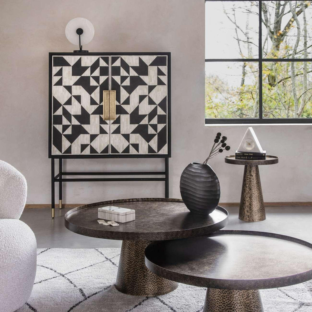 Rustic antique gold side table with textured finish in modern living room setting.