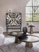 Rustic antique gold side table with textured finish in modern living room setting.