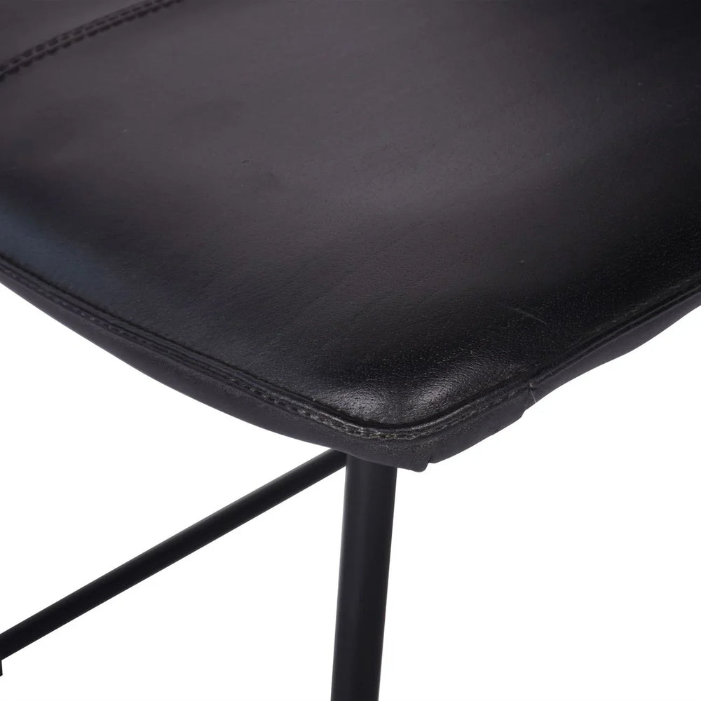 Charcoal leather chair seat with visible stitching detail.