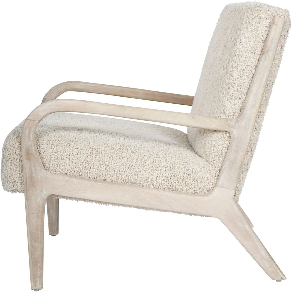 Side view of a beige textured chair with a light wooden frame.
