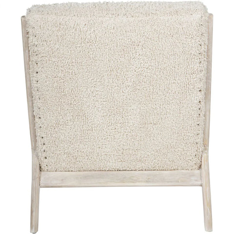 Beige textured chair back with light wood frame.