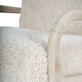 Cream textured chair with curved wooden armrest detail.