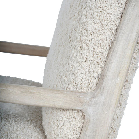 Beige textured chair fabric with light wood frame detail.
