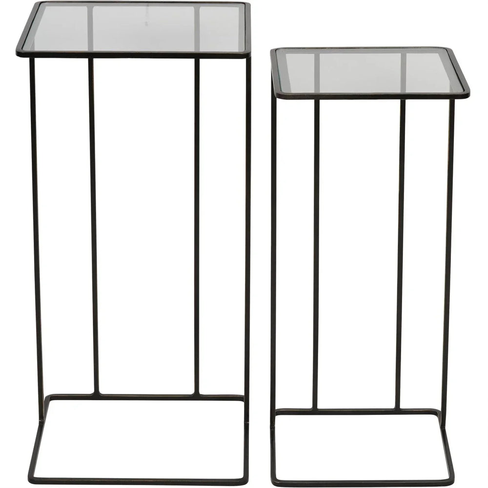 Two dark bronze side tables with glass tops and slender metal frames.