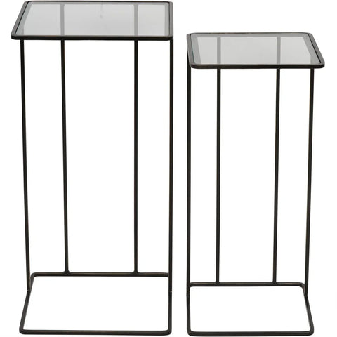 Two dark bronze side tables with glass tops and slender metal frames.
