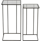 Two dark bronze side tables with glass tops and slender metal frames.