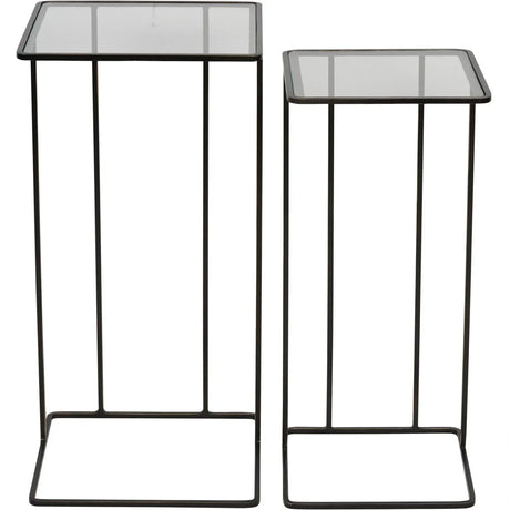 Two dark bronze side tables with glass tops and slender metal frames.