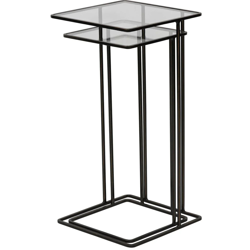Dark bronze metal side table with glass top and minimalist design.