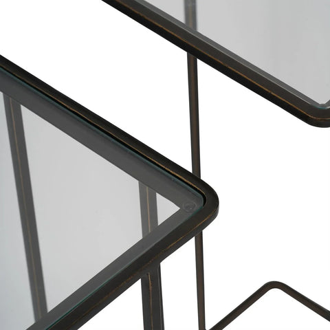 Dark bronze side tables with glass tops, corner detail.