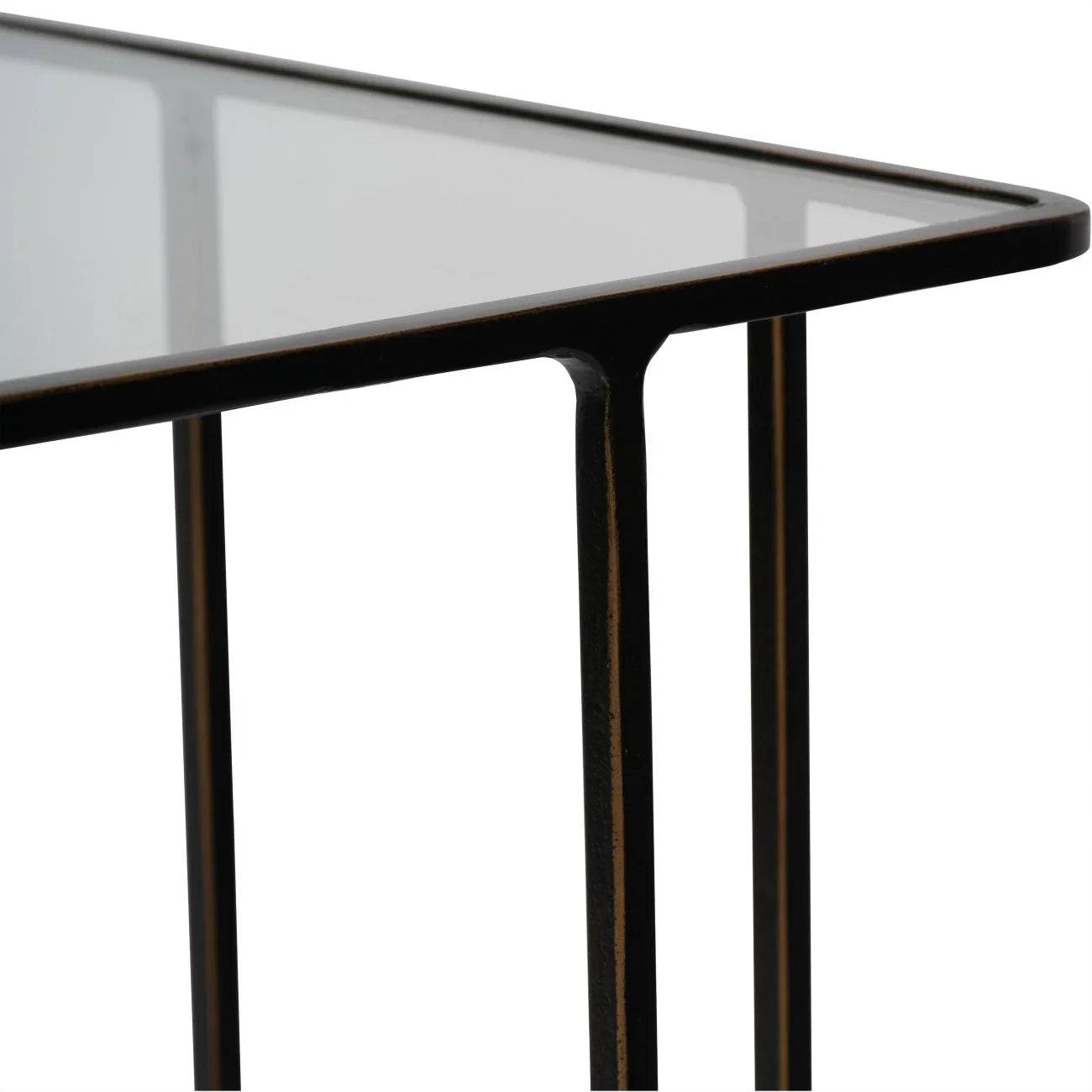 Dark bronze side table corner with glass top and sleek metal legs.