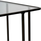 Dark bronze side table corner with glass top and sleek metal legs.