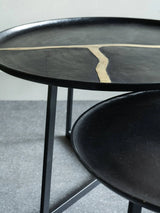 Black aluminium coffee tables with textured surfaces and unique design accents.