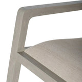 Beige fabric seat with grey wooden armrest detail.