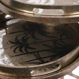 Antique gold tray tables with palm tree design and cutout handles.
