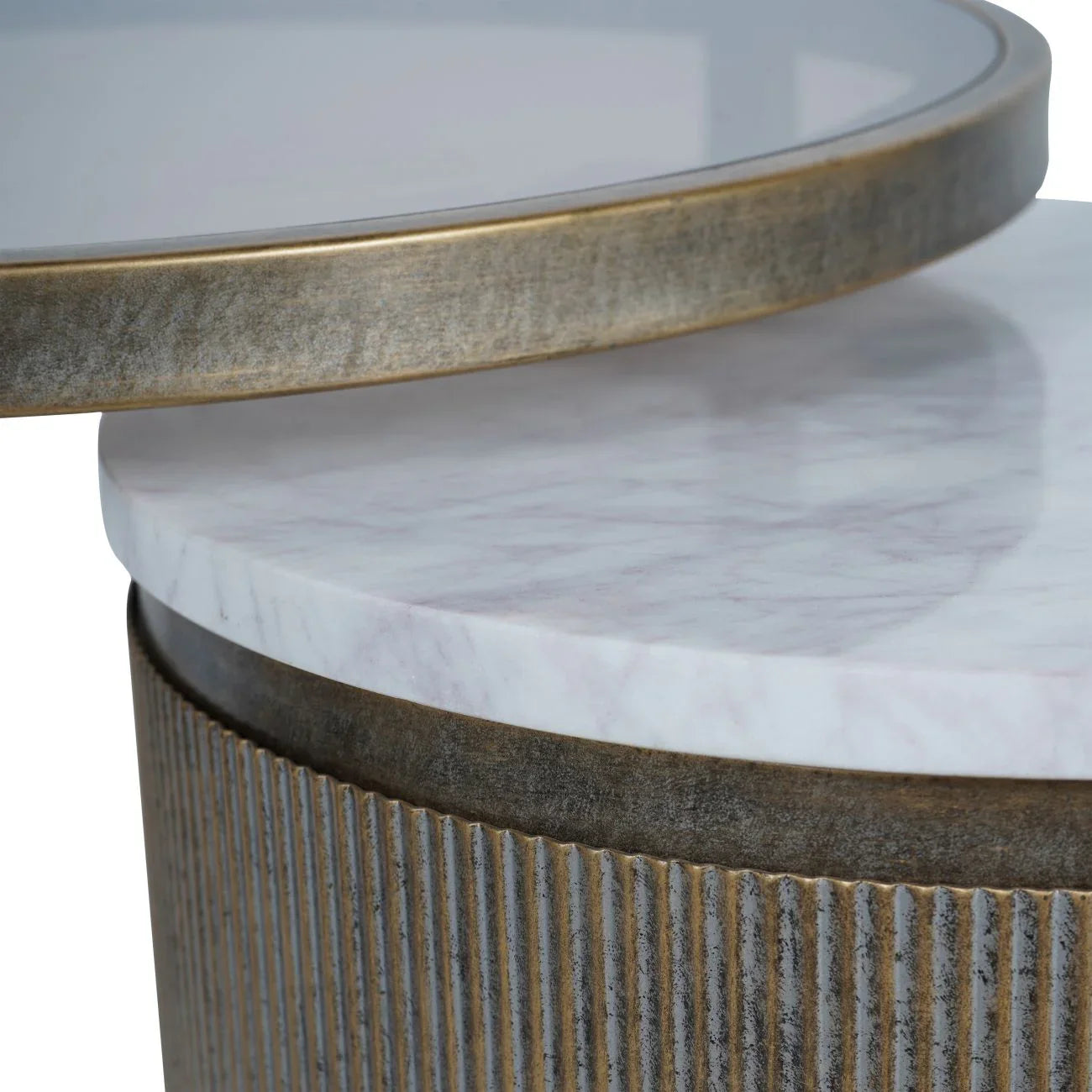 Aged gold nesting tables with marble tops and ribbed metal edges.